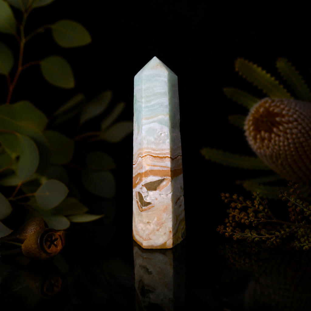Polished Caribbean Blue Calcite crystal point with soft blue and cream natural mineral patterns